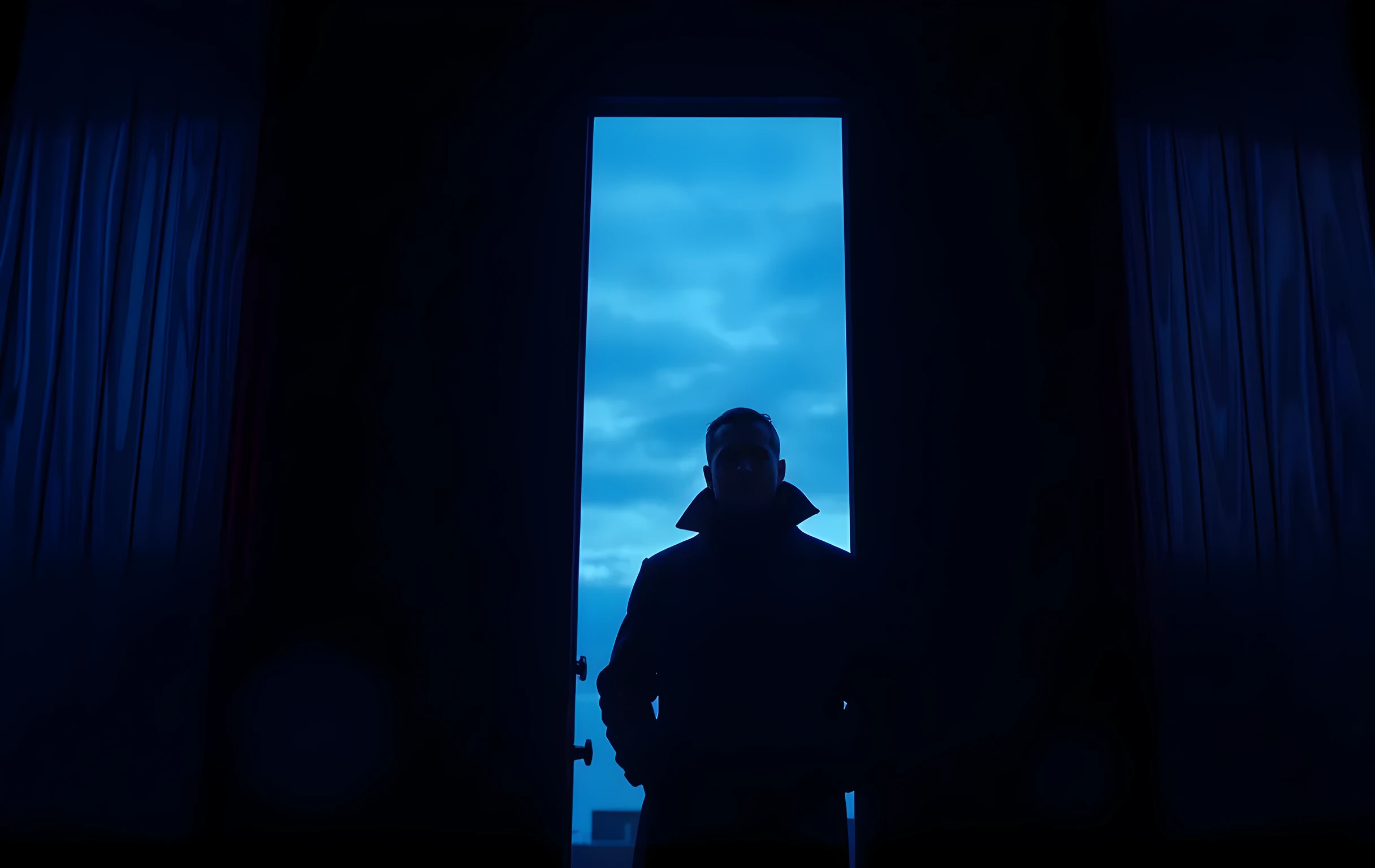 A weathered stage door frame bathed in cool blue twilight, with a performer standing just inside the threshold, coat collar turned up against the evening air. The focus rests on the silhouette and the worn wood grain, leaving the figure partially obscured by depth and atmosphere
